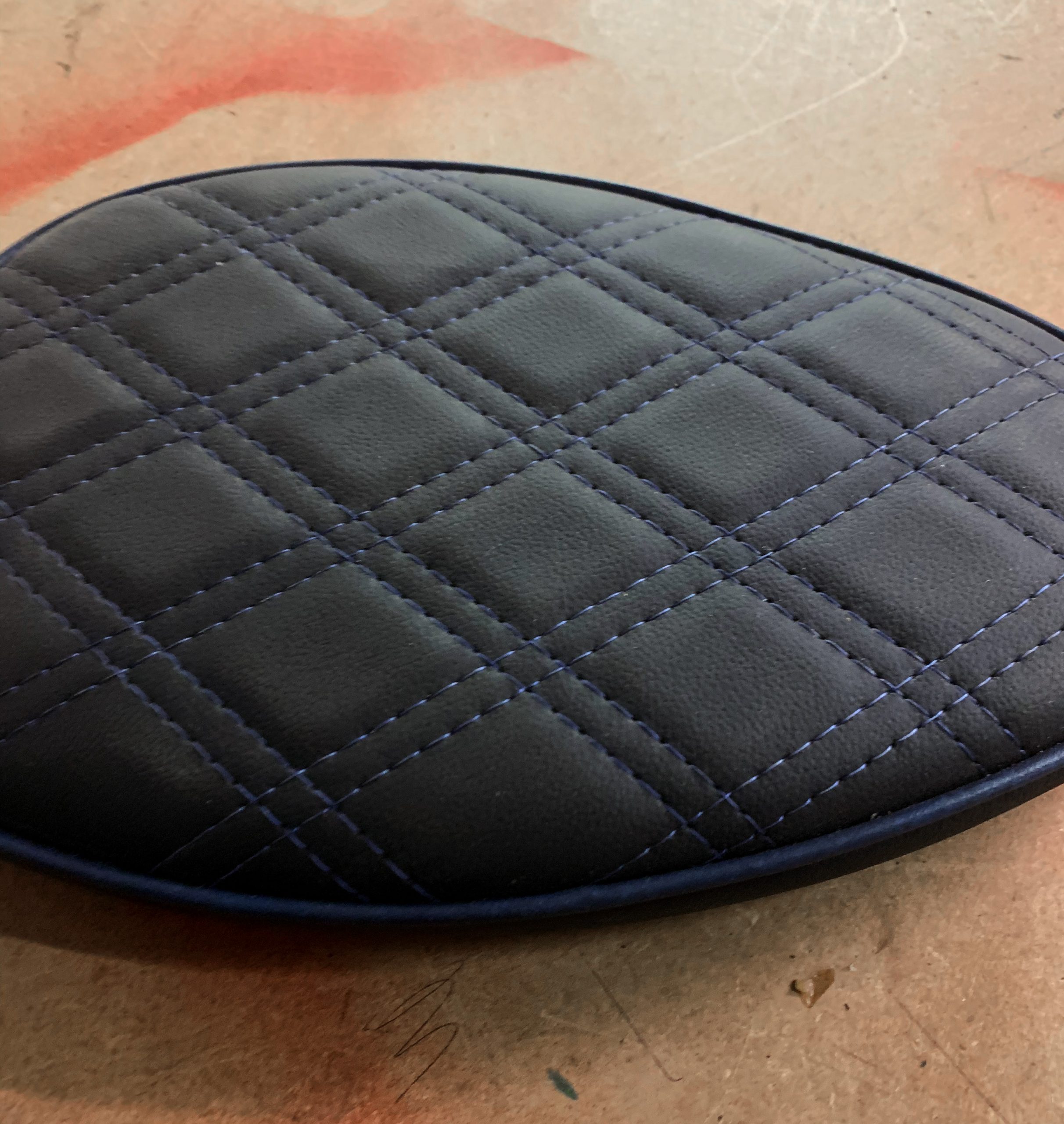 Dark+blue+stitching+and+pipe+on+a+custom+black+leather+motorbike+seat